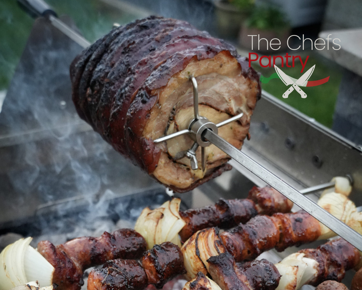 Meat skewers being grilled on a rotisserie with 'The Chef's Pantry' logo.